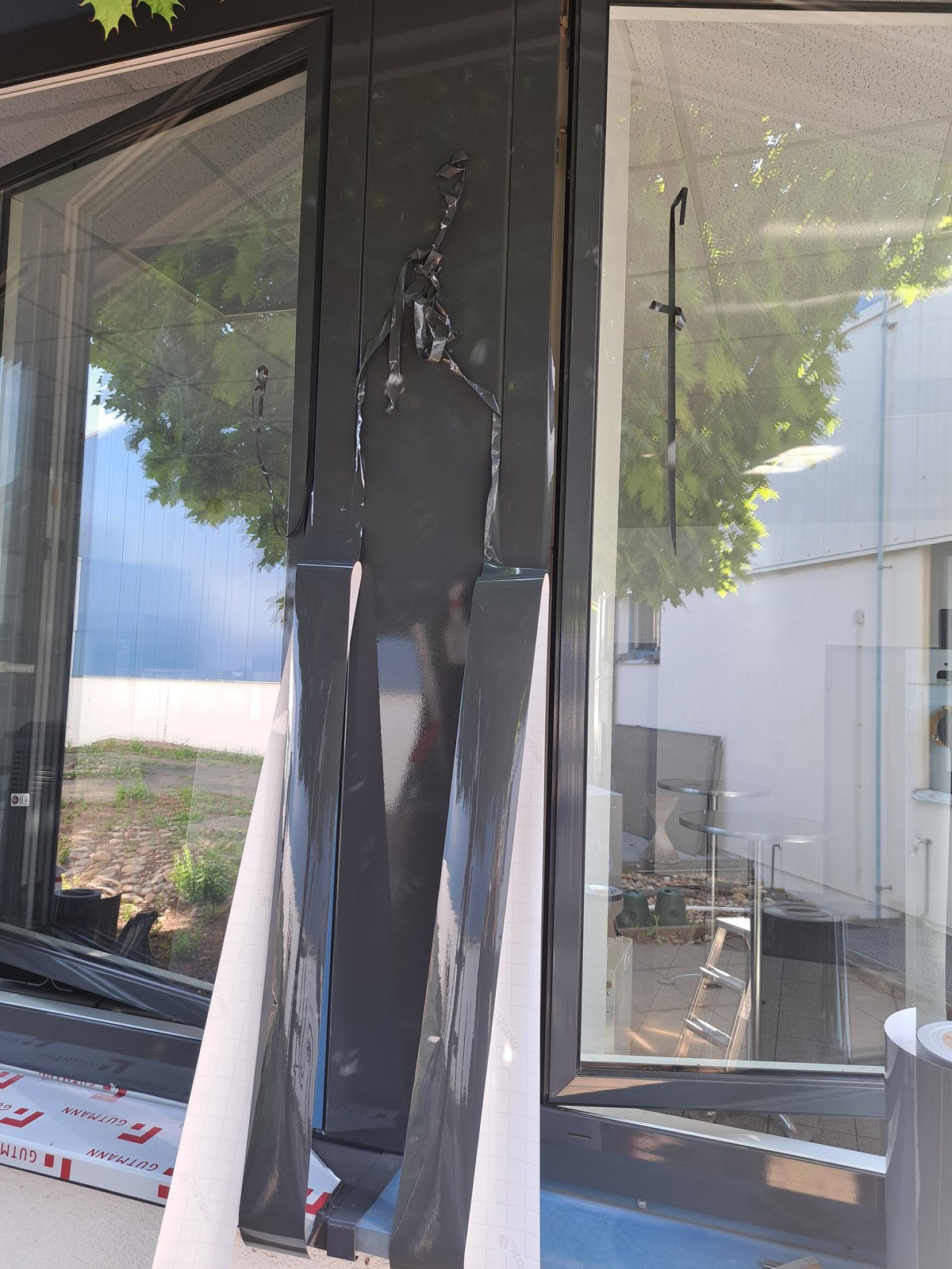 Folienmaterial wird an einem Fensterrahmen bearbeitet